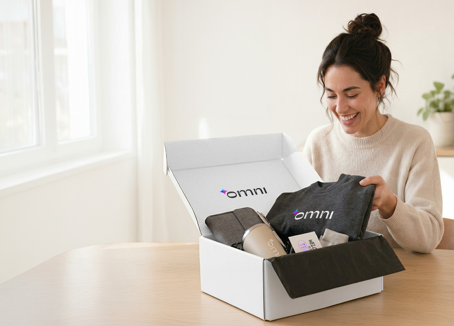 Customer smiling while unboxing an Omni branded welcome kit